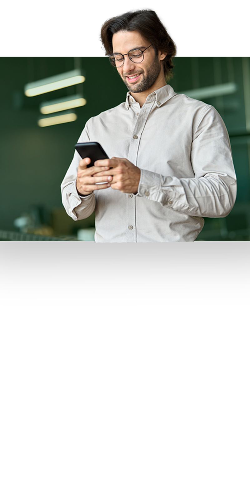 Executive checking his smartphone in a modern office