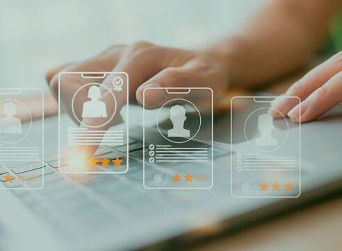 Hands selecting digital candidate profiles